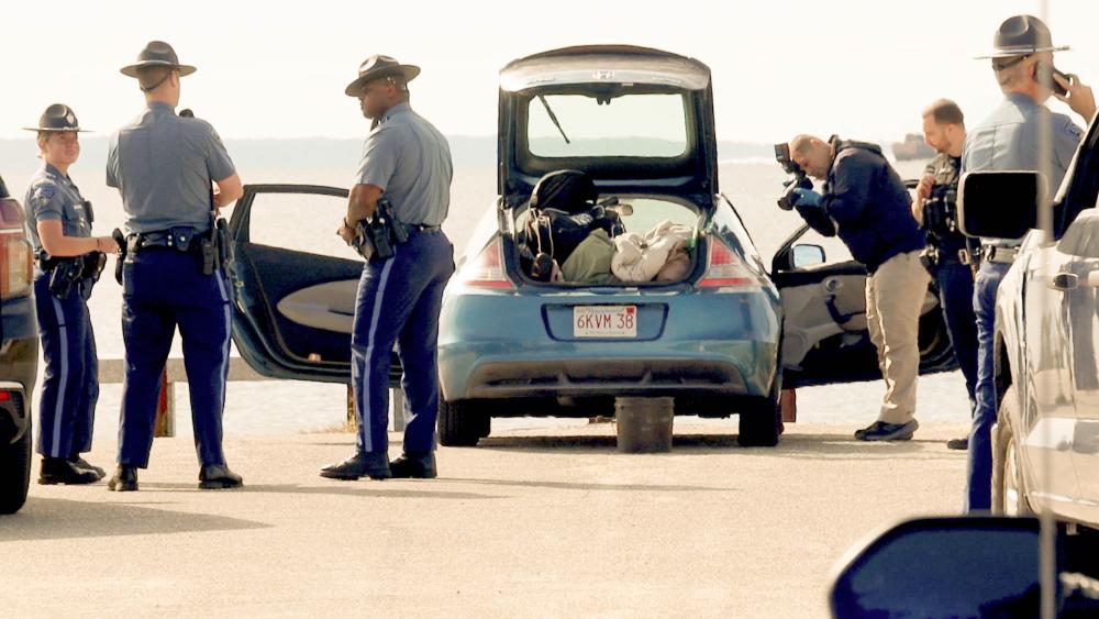 Police searching the vehicle at Swifts beach. Photos by David Curran