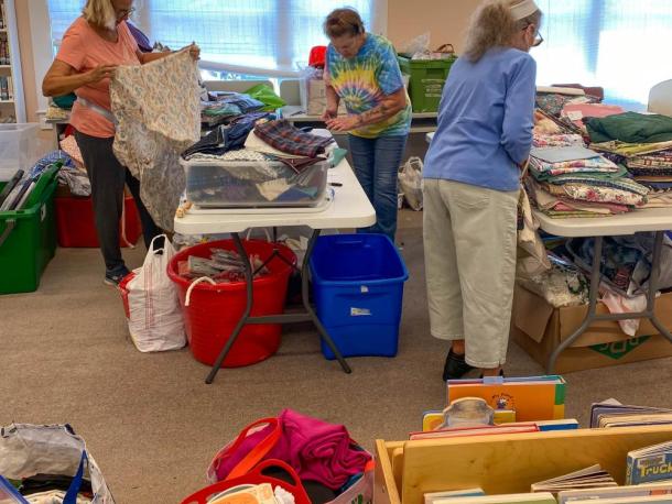 From left to right, Louise Paolella, Harriet Green and Maureen Cunningham measure and sort fabric. Photos by Sue Jackson