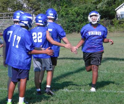 Players high five during warmups. Photo by Christian Uva