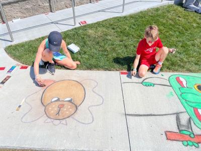 Cassidy Crompton, 10, drew a dog with a bowtie, while her brother, Chace, 8 drew a character from "Minions and Monsters." Photo by Christian Uva
