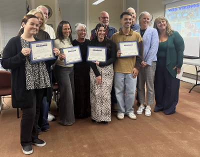 Fourteen district teachers received professional status.