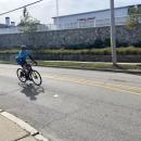 A cyclist rounds the bend on Sandwich Road. 