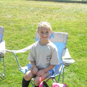 Scarlett Braley, 6, rests after her first game of the season.