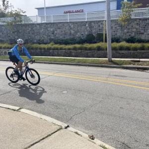 A rider passes Tobey Hospital. 