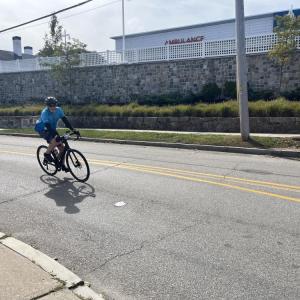 A cyclist rounds the bend on Sandwich Road. 