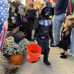 Darth Vader makes his way down the sidewalk. 